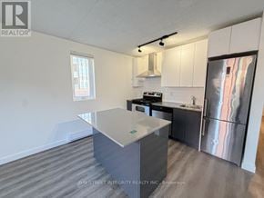 Toronto (South Riverdale) apartment for rent - A kitchen with a refrigerator, stove, and sink.