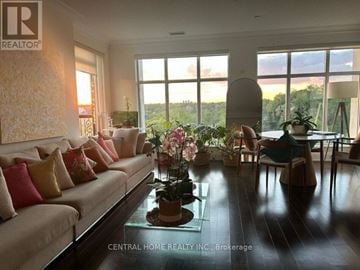 Toronto (High Park-Swansea) condo for rent - A living room with a couch, chairs, and a table with flowers on it.
