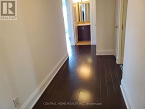 Toronto (High Park-Swansea) condo for rent - A hallway with wood flooring and white walls.