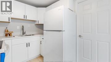 Windsor apartment for rent - A kitchen with white cabinets and a white refrigerator.