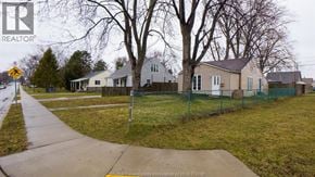 Windsor apartment for rent - A realtor photo of a residential area with houses and a street sign.