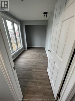 Windsor apartment for rent - A room with a white door and a window with a view of a fence and trees.