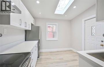 Hamilton apartment for rent - A kitchen with white cabinets and a skylight.