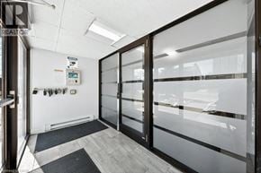 Kitchener condo for rent - A glass door with a black mat in front of it.