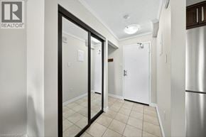 Kitchener condo for rent - A hallway with a white door and a black door.