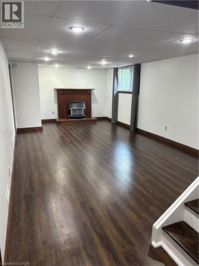 Stoney Creek apartment for rent - A living room with wood floors and a fireplace.