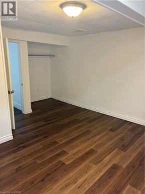 Stoney Creek apartment for rent - A room with wooden flooring and a doorway leading to another room.