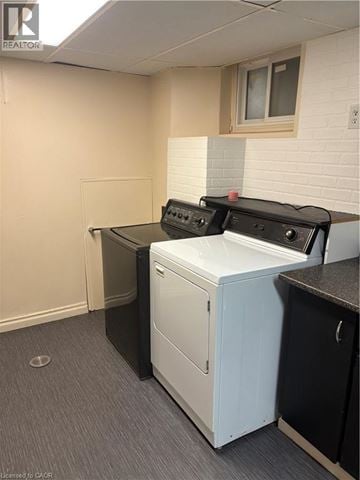 Stoney Creek apartment for rent - A white dishwasher is in a kitchen with a black counter.