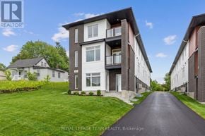 Ottawa multi-family for rent - A road leads to a building with a sign that says Royal LePage Team Realty, Brokerage.