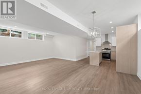 Ottawa multi-family for rent - A spacious room with a kitchenette and a dining area.