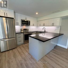 Toronto (Victoria Village) apartment for rent - A kitchen with a refrigerator, microwave, oven, and sink.