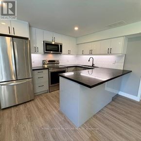 Toronto (Victoria Village) apartment for rent - A kitchen with a refrigerator, microwave, and oven.