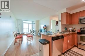 Mississauga condo for rent - A kitchen with wooden floors and a large island with a sink.