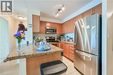 Mississauga condo for rent - A kitchen with a granite counter top and stainless steel appliances.