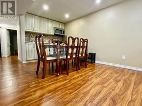 Toronto (Centennial Scarborough) townhouse for rent - A dining room with a wooden table and chairs.