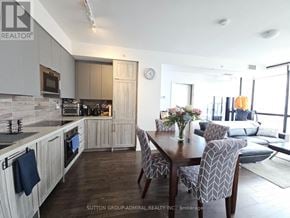 Vaughan (Concord) condo for rent - A modern kitchen with a dining table set for four.