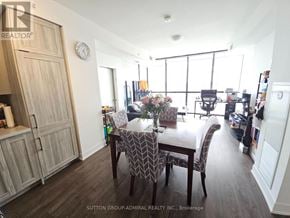 Vaughan (Concord) condo for rent - A dining room with a wooden table and chairs.