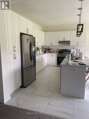 Brant (Paris) apartment for rent - A kitchen with a refrigerator, oven, and sink.