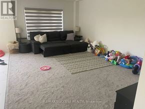 Brant (Paris) apartment for rent - A living room with a grey sofa, a grey rug, and a white wall.