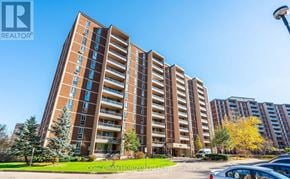 Hamilton (Ainslie Wood) condo for rent - A large apartment building with a parking lot in front.
