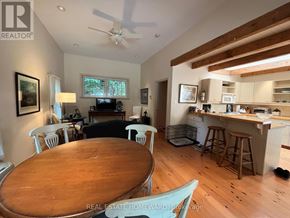 Rideau Lakes apartment for rent - A dining room with a wooden table and chairs.