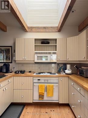 Rideau Lakes apartment for rent - A kitchen with wooden cabinets and a stove top oven.