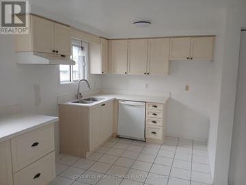 Guelph (Kortright West) apartment for rent - A kitchen with white cabinets and a white dishwasher.
