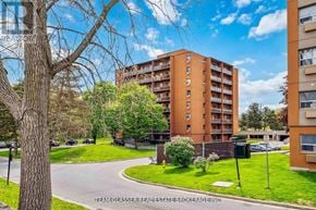 London North (North C) condo for rent - A residential building with a green lawn in front.