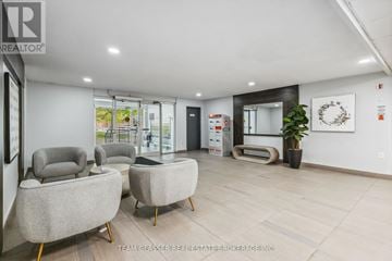 London North (North C) condo for rent - A modern living room with grey armchairs and a wooden floor.