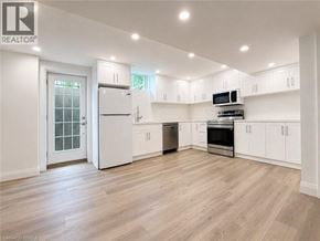 Binbrook apartment for rent - A spacious kitchen with white cabinets and appliances.