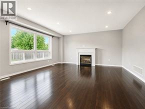 Binbrook apartment for rent - A spacious living room with a fireplace and hardwood floors.