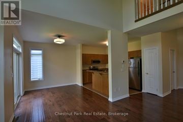 Collingwood house for rent - A spacious kitchen with a refrigerator, sink, and cabinets in a Chestnut Park Real Estate Brokerage property.