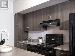 Toronto (Bay Street Corridor) condo for rent - A modern kitchen with a brokerage sign on the wall.