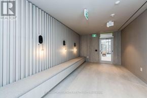 Toronto (Waterfront Communities) condo for rent - A long hallway with a white ceiling and a door at the end.