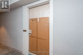 Toronto (Waterfront Communities) condo for rent - A door with the number 2597 on it is covered in brown paper.