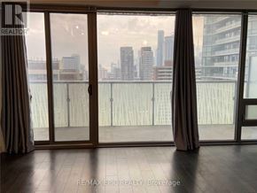 Toronto (Church-Yonge Corridor) condo for rent - A room with a view of the city through large windows.