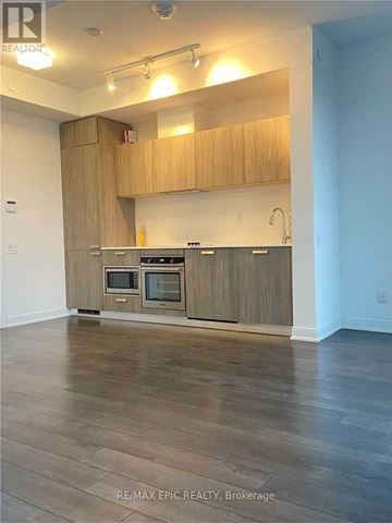 Toronto (Church-Yonge Corridor) condo for rent - A kitchen with wooden cabinets and a countertop.