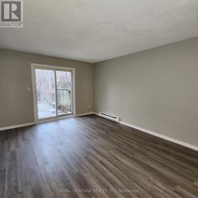 Oshawa (Pinecrest) townhouse for rent - A room with a sliding glass door leading to a backyard.