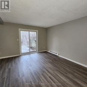 Oshawa (Pinecrest) townhouse for rent - A room with a sliding glass door leading outside.