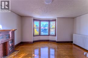 Hamilton apartment for rent - A room with a fireplace and a large window.