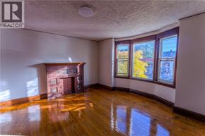 Hamilton apartment for rent - A room with a fireplace and wood flooring.