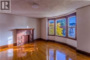 Hamilton apartment for rent - A room with a fireplace and wooden floors.