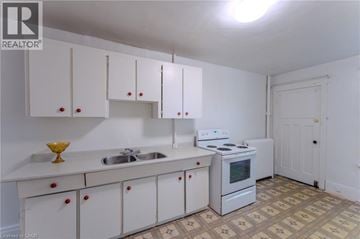 Hamilton apartment for rent - A kitchen with white cabinets and a white stove.