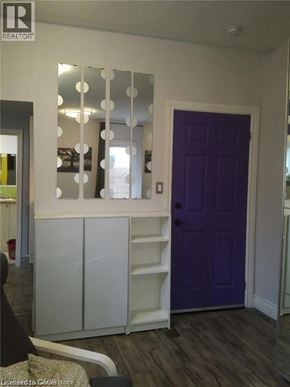 Hamilton apartment for rent - A purple door is in a white hallway.