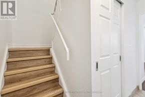 London East (East K) condo for rent - A staircase with wooden steps and white railings.