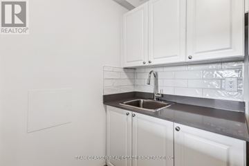 London East (East K) condo for rent - A white kitchen with a sink and cabinets.