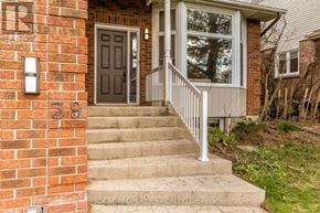 Ottawa apartment for rent - A house numbered 39 with a grey door and a white railing.