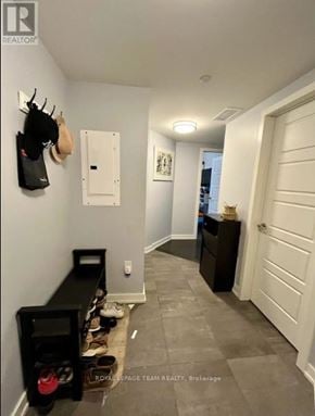 Ottawa condo for rent - A hallway with a coat rack, a shoe rack, and a white door.