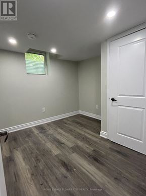 Brantford apartment for rent - A room with a white door and a window with blinds.