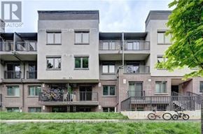 Cambridge townhouse for rent - A building with balconies and bicycles parked on the ground.